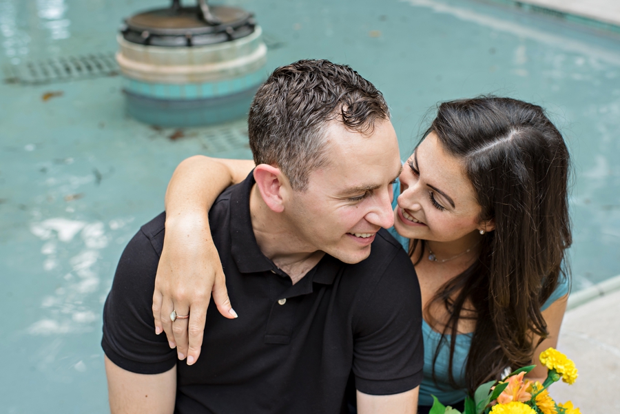 An engaged couple laughing in rittenhouse square.